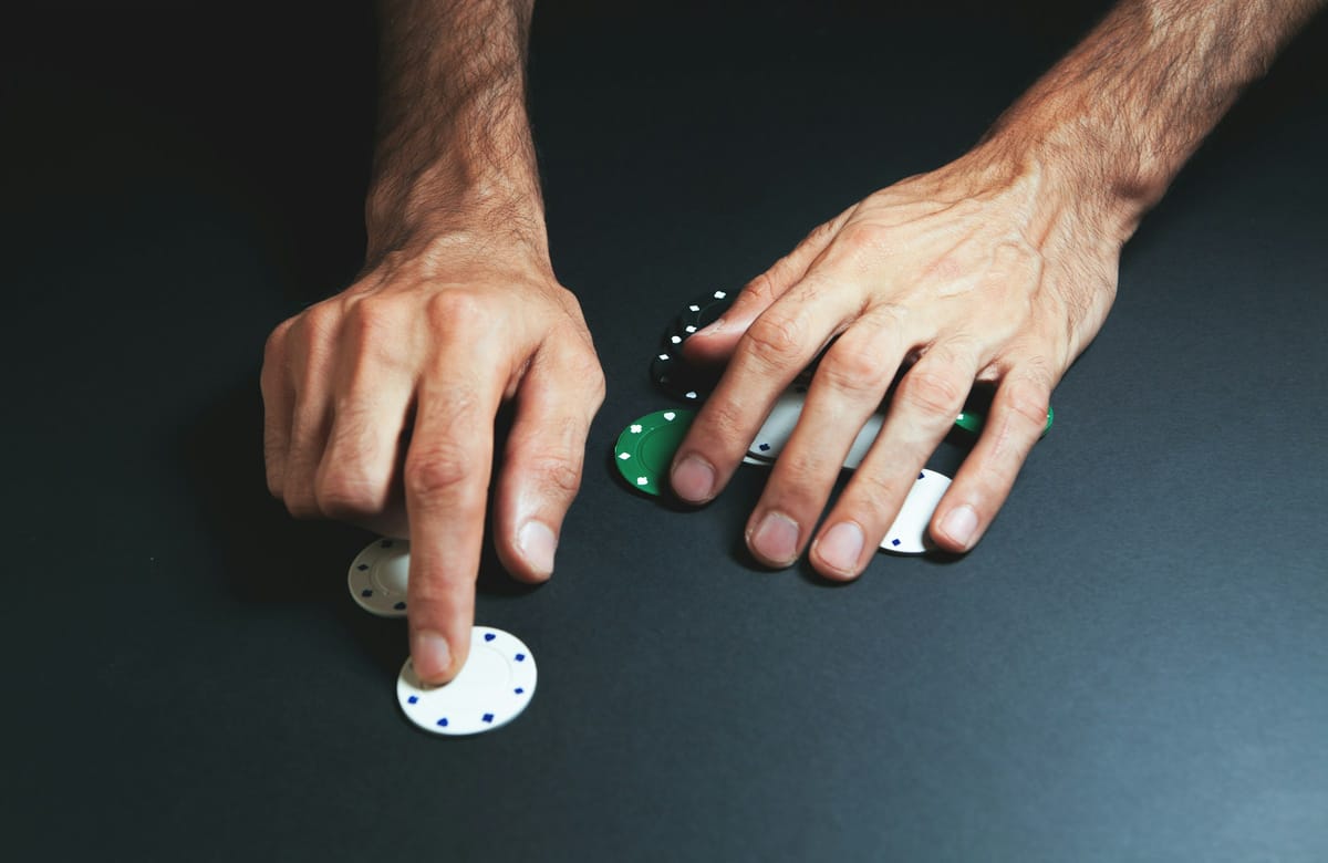 A player stacking casino chips at a table